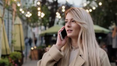 Mutlu genç kadın sokakta yürüme ve kentsel şehir yaşam tarzı zevk cep telefonuyla konuşuyor. Portre kadar kapatın