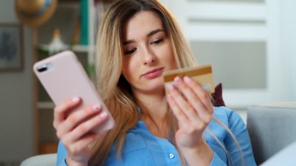 Chica que compra en línea, usando un teléfono inteligente y una tarjeta de crédito en casa, aplicación de teléfono celular de compras. Mujer con tarjeta de crédito, fácil de pagar mediante el uso de la aplicación de dispositivo móvil digital inteligente tecnología de Internet de negocios . — Vídeos de Stock