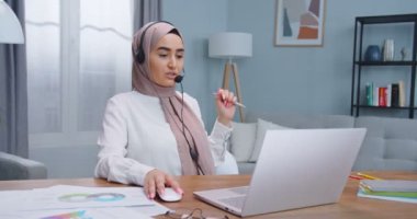 Güzel Müslümanlar dizüstü bilgisayarda çalışan, kulaklık kullanan müşterilerle konuşan serbest yazardan esinlendiler. Kadın iç mekandaki dizüstü bilgisayarını kullanarak sosyal ağda bilgi arıyor ve haberleri okuyor.