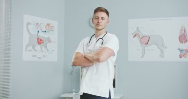 Veteriner laboratuvar çalışanının orta planı, ellerini göğsüne koyması. Steteskoplu veteriner doktor kameraya bakıyor. Evcil hayvan bakımı, veterinerlik, sağlıklı hayvanlar.