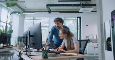 Çekici Kafkas lideri çalışanının çalışmalarını kontrol ediyor. Panodaki bilgilerle bilgisayardaki verileri karşılaştıran bir adam. Patronla konuşurken klavyede yazı yazan meşgul bir kadın..