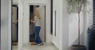 Kot pantolon ve süveter içinde dairesinin kapısını açan sevimli beyaz bir kadın. Taze yiyecek dolu bir çantayla eve giren bir adam. Kadın teslimatı kabul ediyor ve kapıyı kapattıktan sonra uzaklaşıyor..