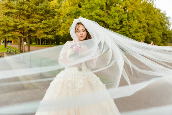 Rüzgarda gelişen peçeli bir gelin portresi.