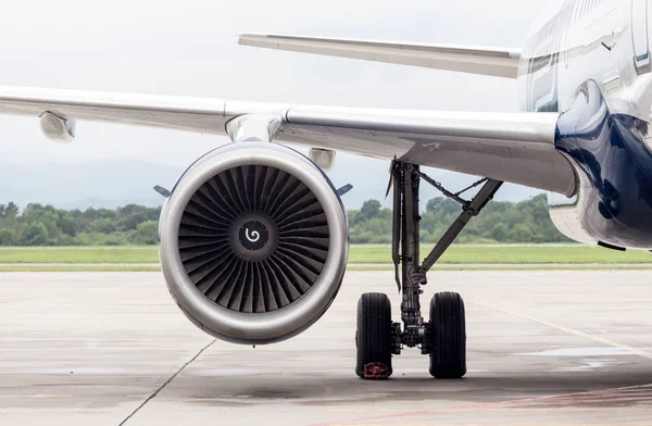 Turbine of airplane\'s engine under wing. Plane on runway. Service and maintenance of airplanes. Aviation and transportation.