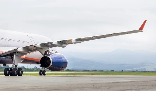 Modern passenger jet airplane on runway. Holidays and journey concept.