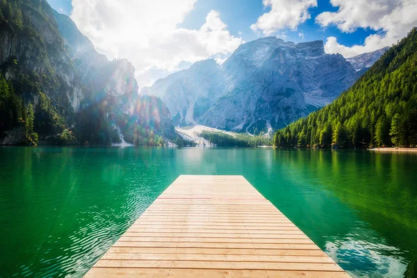 Braies Lake in Dolomites mountains Seekofel in background, Sudtirol, Italy. Lake Braies is also known as Lago di Braies. The lake is surrounded by the mountains which are reflected in the water.