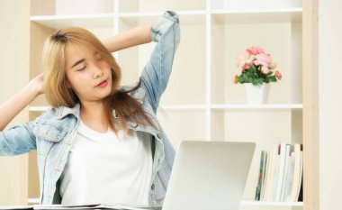 Çalışma ofisinde bittiğinde rahat genç kadın kol ve omuz kas uzanır. Memnun ve endişesiz iş iş kavramı.