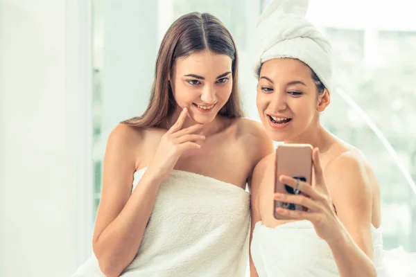 Happy women takes selfie photo with mobile phone in luxury spa after aromatherapy massage. Luxury wellness lifestyle and social media information sharing concept.