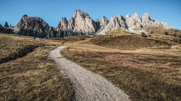 stock image Dirt road and hiking trail track in Dolomites mountain, Italy, in front of Pizes de Cir Ridge mountain ranges in Bolzano, South Tyrol, Northwestern Dolomites, Italy.