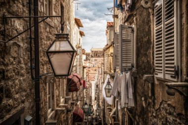 Famous narrow alley of Dubrovnik old town in Croatia - Prominent travel destination of Croatia. Dubrovnik old town was listed as UNESCO World Heritage Sites in 1979. clipart