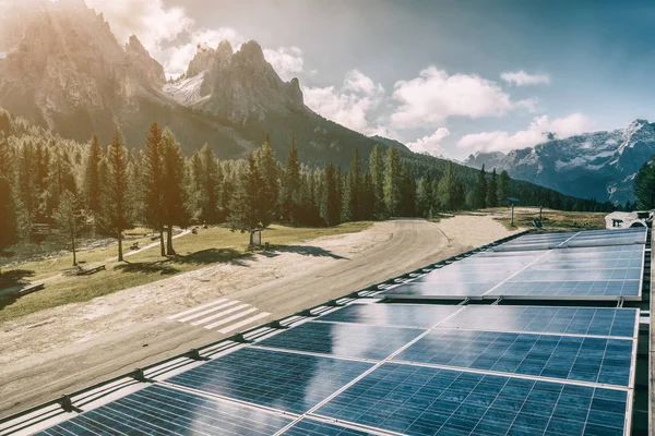 Solar cell panel in country landscape against sunny sky and mountain backgrounds. Solar power is the innovation for sustainability of world energy. Sustainable resources.