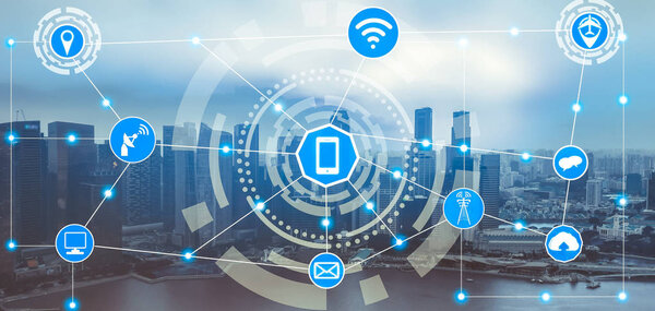 Smart city wireless communication network with graphic showing concept of internet of things ( IOT ) and information communication technology ( ICT ) against modern city buildings in the background.
