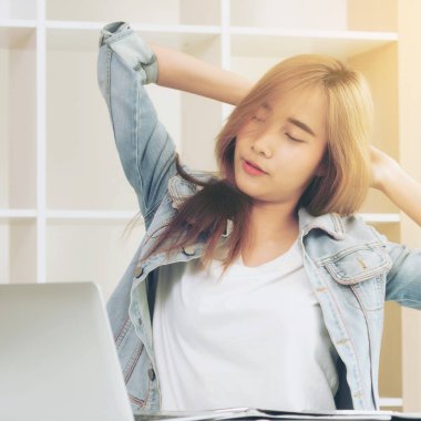 Çalışma ofisinde bittiğinde rahat genç kadın kol ve omuz kas uzanır. Memnun ve endişesiz iş iş kavramı.