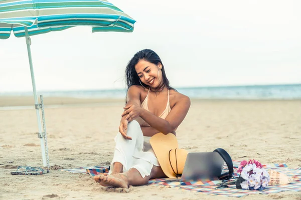 Artı boyutu yaz aylarında tropikal Kum Plajı üzerinde oturan bir genç bayan. Tatil seyahat etmek tatil.