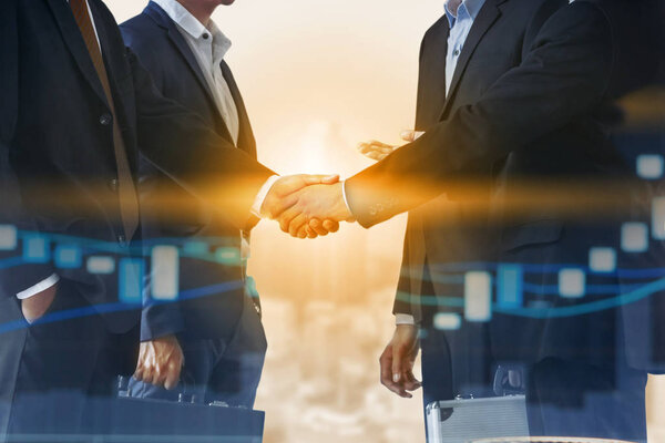 Double exposure business people handshake agreement with cityscape in background. Business executive meeting and collaboration.