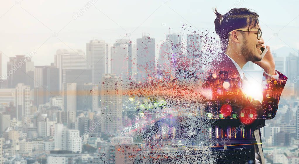 Surreal Image of Communication Concept - Young businessman using mobile phone with modern city buildings background. Future innovation technology and internet of things ( IOT ).