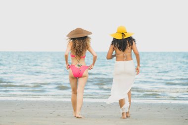 Bikinili mutlu kadın birlikte yaz tatil tropikal kum plaj güneşlenme gitmek. Seyahat yaşam tarzı.