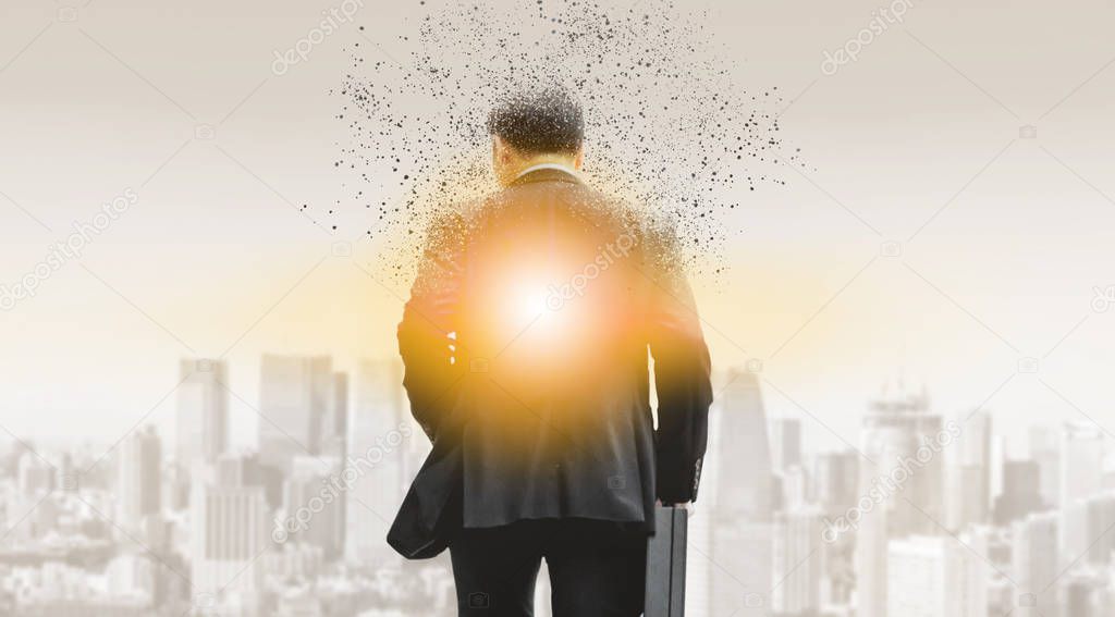 Surreal image of businessman in business suit walking away to modern business buildings and cityscape in the background. Digital innovation and technology disruption concept.