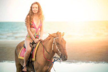 Yaz aylarında sahilde bir binicilik kadın bir modeldir. Lüks seyahat etmek tatil.