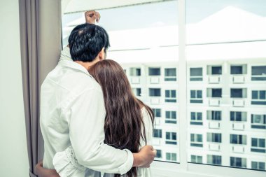 Mutlu genç çift rahatlatıcı sabah uyandıktan sonra eve yatak odasında.