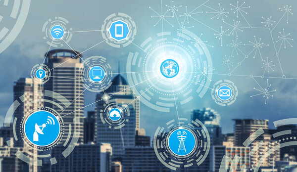 Smart city wireless communication network with graphic showing concept of internet of things ( IOT ) and information communication technology ( ICT ) against modern city buildings in the background.