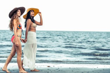 Bikinili mutlu kadın birlikte yaz tatil tropikal kum plaj güneşlenme gitmek. Seyahat yaşam tarzı.