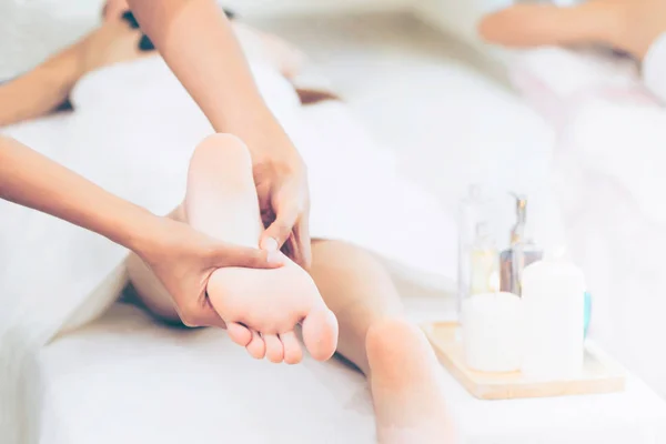 Foot spa massage treatment by professional massage therapist in luxury spa resort. Wellness, stress relief and rejuvenation concept.