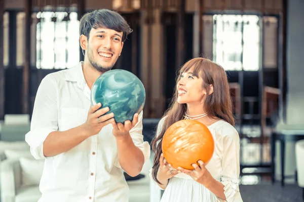 Young couple playing bowling at the club. Sport and recreation lifestyle.