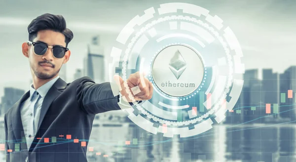 Ethereum and cryptocurrency investing concept - Businessman pointing at Ethereum coin (ETH) with modern business building and cityscape in the background. Blockchain technology.