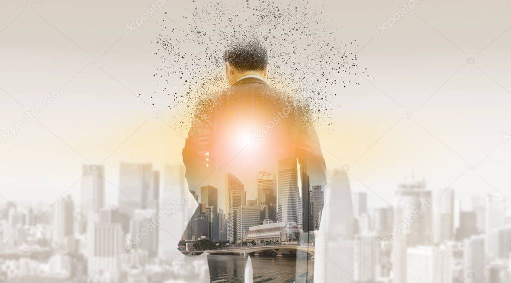 Surreal image of businessman in business suit walking away to modern business buildings and cityscape in the background. Digital innovation and technology disruption concept.