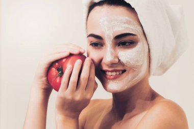 Bir yüz maskesi tedavi ile domates krem ayıklayabilirsiniz doğa tedavisinin yararı gösterilen sahip güzel bir kadın. Anti-aging kozmetik, yüz cilt bakımı ve lüks yaşam tarzı kavramı.