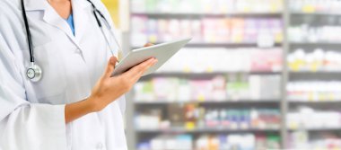 Pharmacist using tablet computer at the pharmacy. Medical healthcare and pharmaceutical staff service. clipart