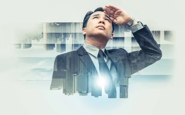 Double exposure - Business leader vision for success, looking away with modern buildings in city background. Concept of talented leadership.