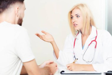 Kadın doktor hastane office erkek hastada konuşuyor. Sağlık ve tıbbi hizmet.