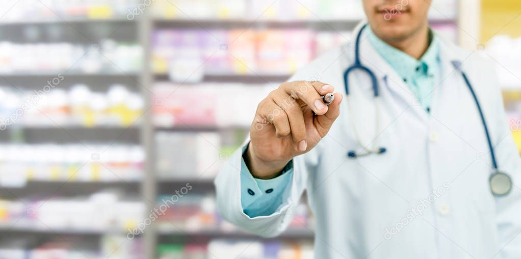 Pharmacist in pharmacy pointing pen at empty copy space for your text. Healthcare and pharmaceutical service.