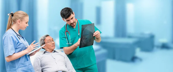 Surgeon showing xray film to senior patient looking at brain injuries with nurse standing beside the surgeon at the hospital room. Medical healthcare and surgical doctor service concept.