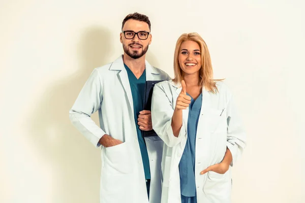 Portrait of confident GP doctor and surgical doctor on white background.