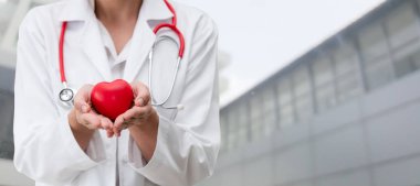 Kırmızı bir kalp Hastanesi ofiste tutan doktor. Tıbbi doktor ve sağlık personeli hizmet anlayışı.