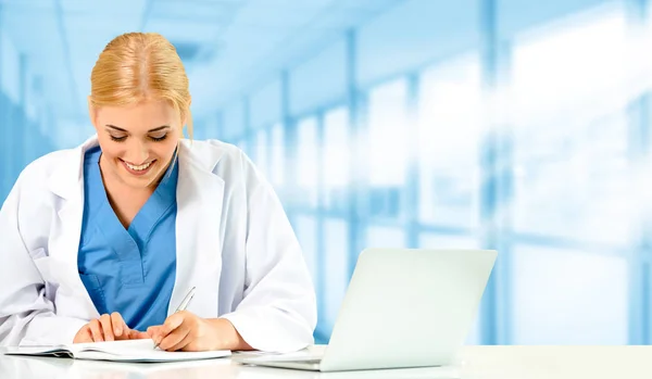 Doctor using laptop computer at the hospital. Medical healthcare and doctor staff service.