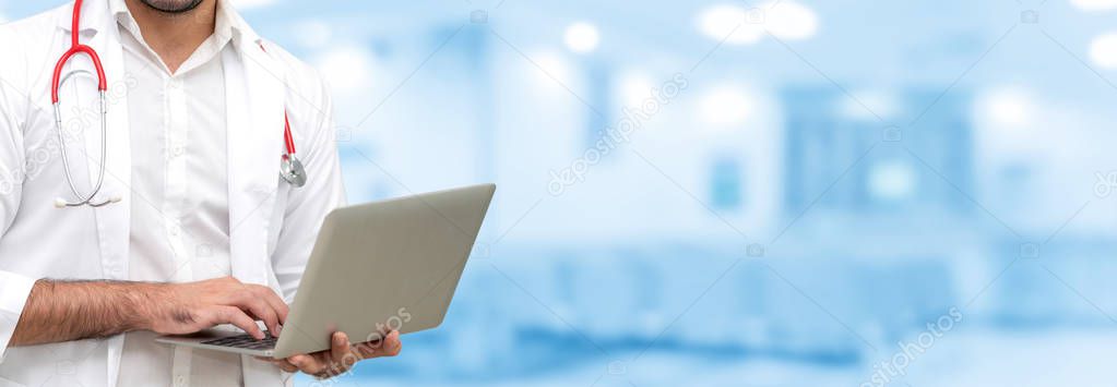 Doctor using laptop computer at the hospital. Medical healthcare and doctor staff service.