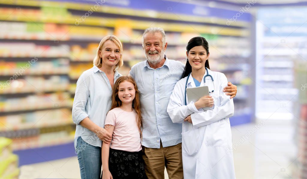 Doctor with happy family of mother, father and daughter at the pharmacy or hospital. Medical healthcare and doctor service.