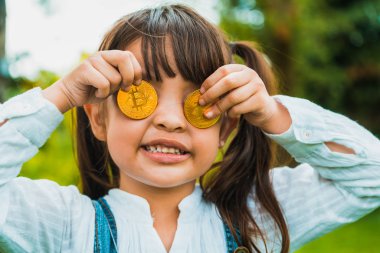 Bitcoin dijital para tutan küçük bir kız çocuk. Yatırım ve ticaret kolay bitcoin kavramı.