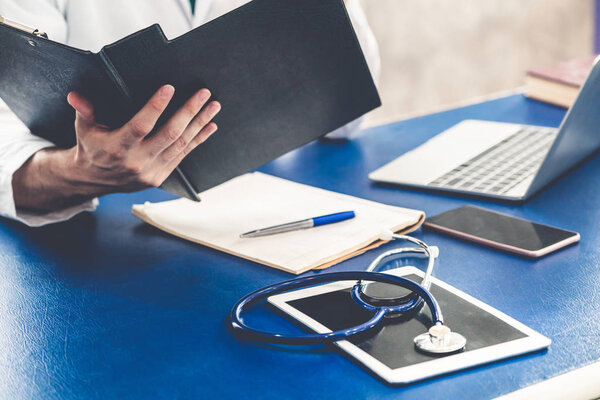 Doctor working in hospital office. Medical healthcare concept.