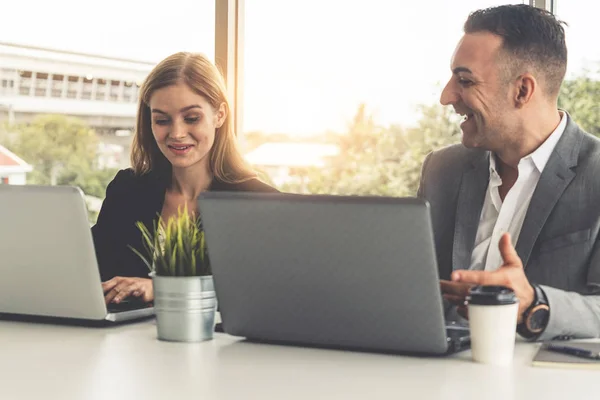 Businessman executive is in meeting discussion with a businesswoman worker in modern workplace office. People corporate business team concept.