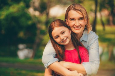Rahat mutlu anne ve küçük çocuk kız açık havada genel Park. Ebeveyn ve çocuk kavramı.