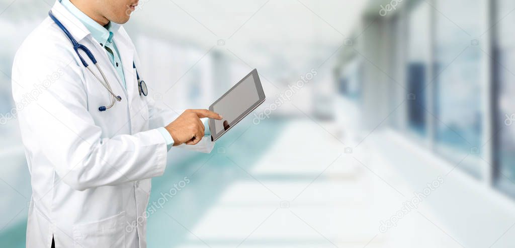 Male doctor using tablet computer at hospital. Medical research staff and doctor service.