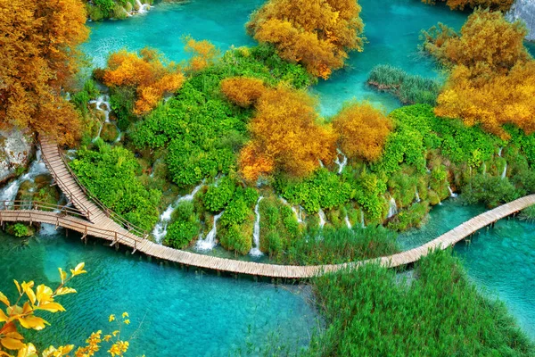 Beautiful wooden path trail for nature trekking with lakes and waterfall landscape in Plitvice Lakes National Park, UNESCO natural world heritage and famous travel destination of Croatia.