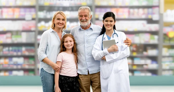 Doctor with happy family of mother, father and daughter at the pharmacy or hospital. Medical healthcare and doctor service.