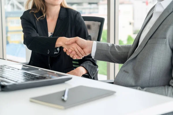 Businessman executive handshake with businesswoman worker in modern workplace office. People corporate business deals concept.