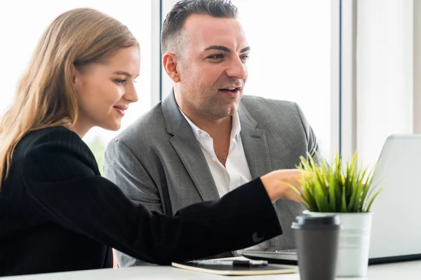 Businessman executive is in meeting discussion with a businesswoman worker in modern workplace office. People corporate business team concept.